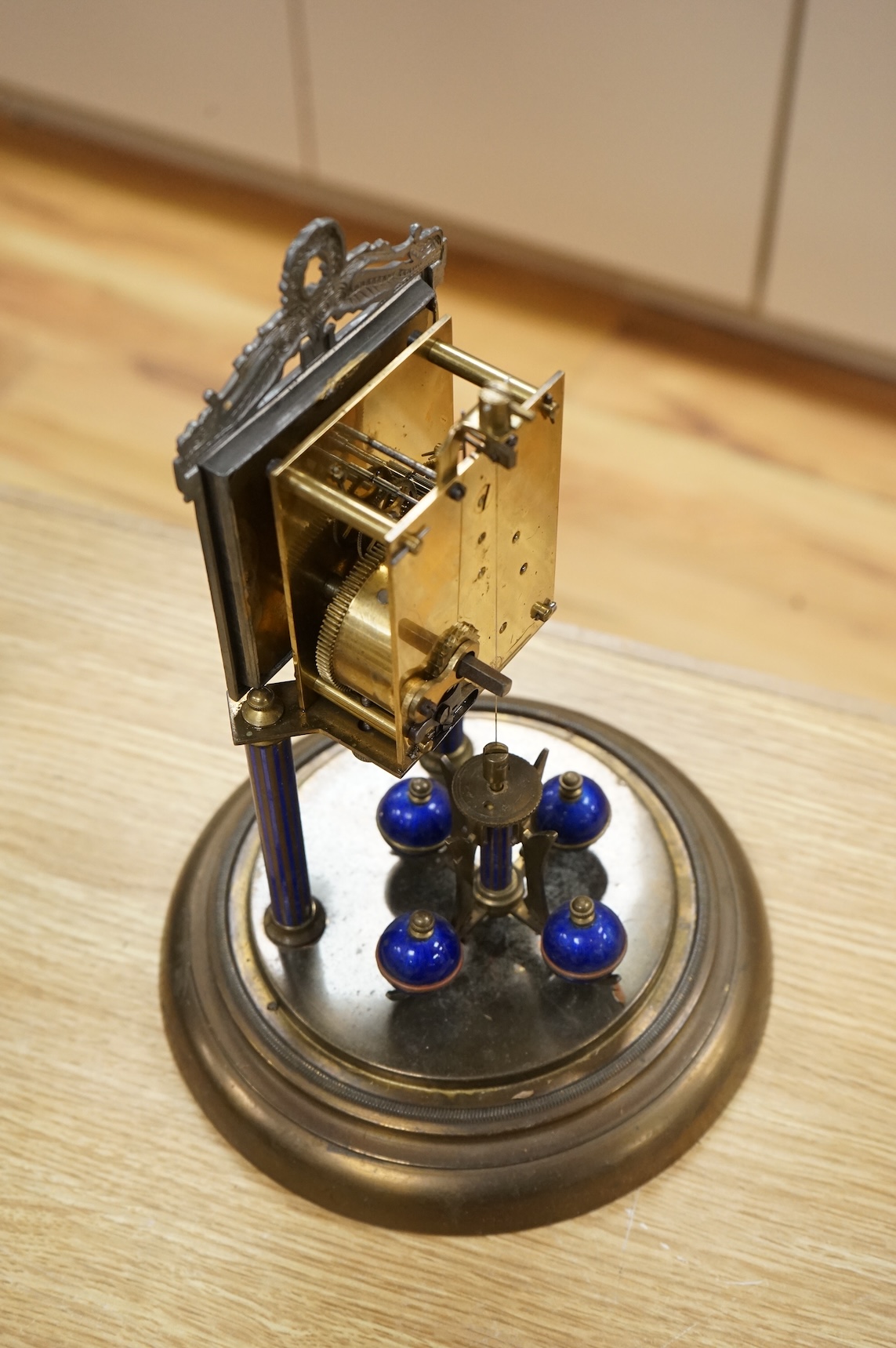 A Jahresuhrenfabrik anniversary clock with blue-enamelled dial, under glass dome, 32cm